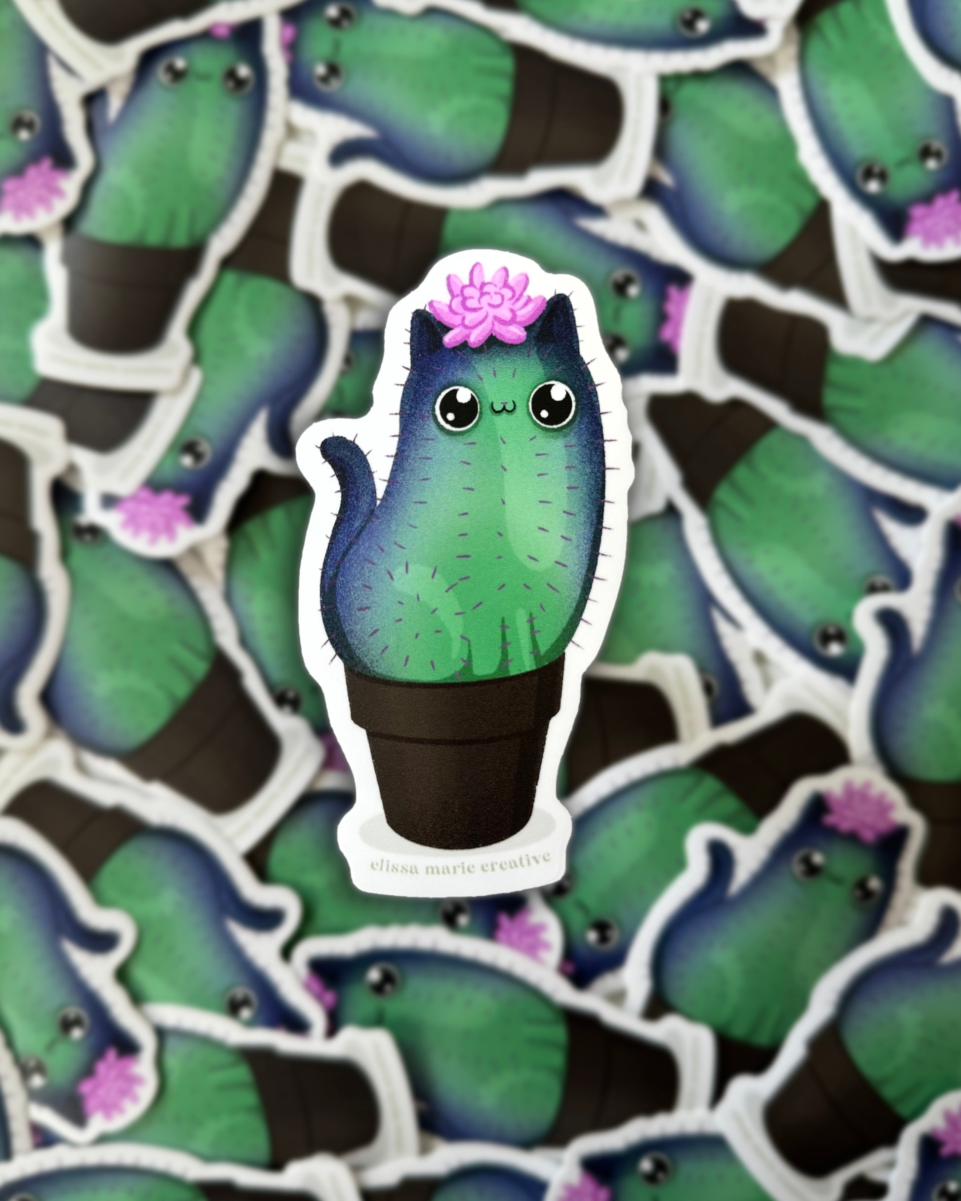 A sticker with a cat-shaped cactus design, featuring a green and purple color scheme and a cactus flower, surrounded by a pattern of similar stickers.