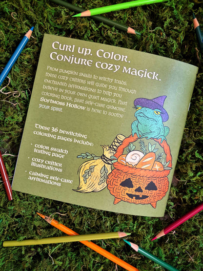 Coloring book back cover with the headline 'Curly up. Color. Conjure Cozy Magick.' on a mossy background with colored pencils.